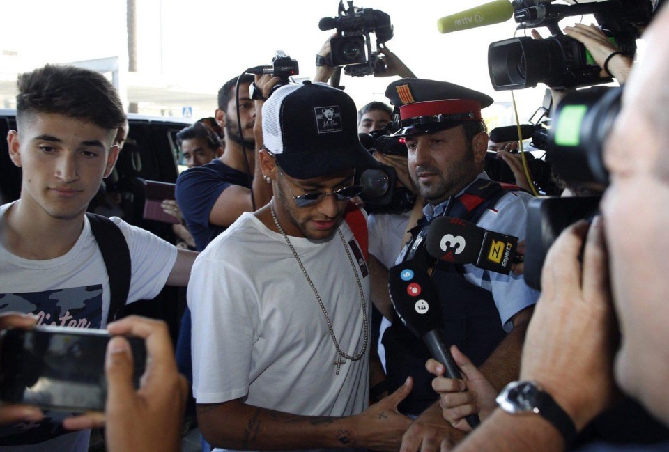 Neymar was mobbed by photographers as he arrived at Barcelona Airport