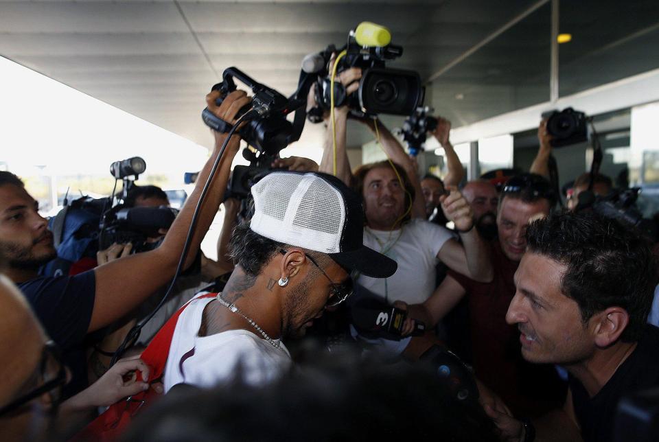 Neymar had to make his way through a scrum of photographers and cameramen as he arrived at Barcelona Airport