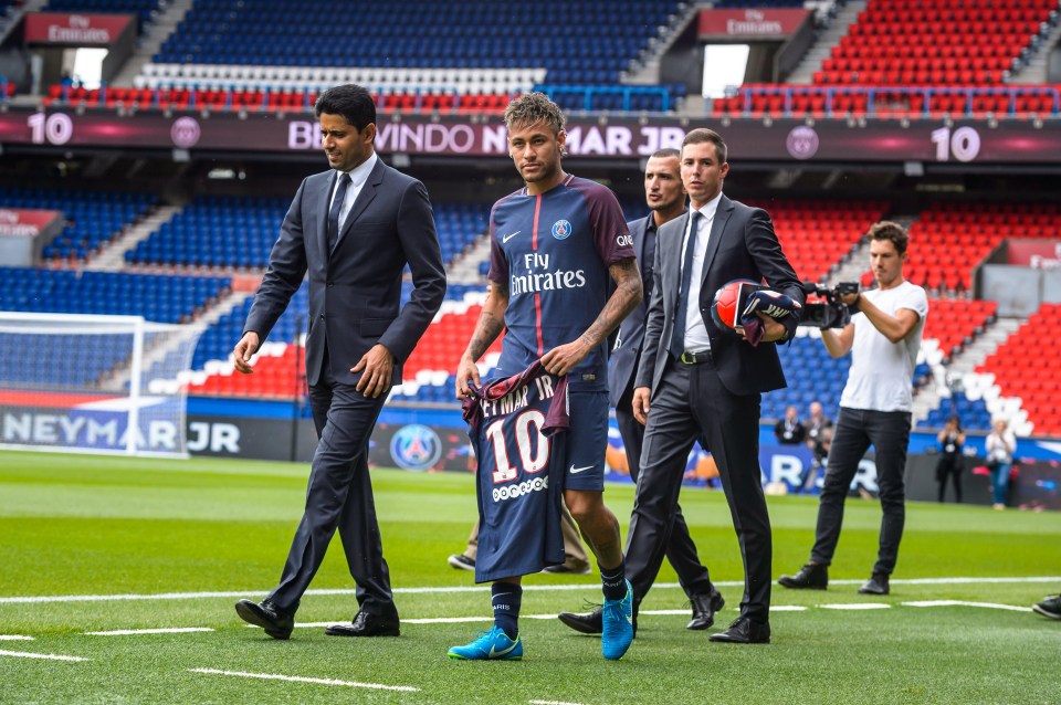 Neymar carries a jersey with his name on after moving to Paris Saint-Germain for a world record fee