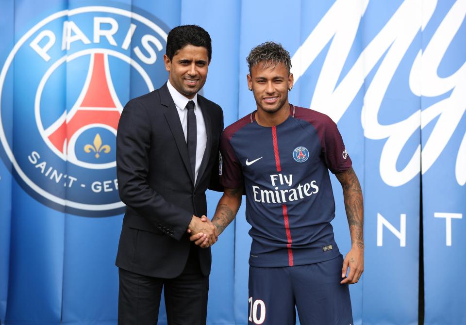 Neymar shakes hands with Paris Saint-Germain president Nasser Al-Khelaifi