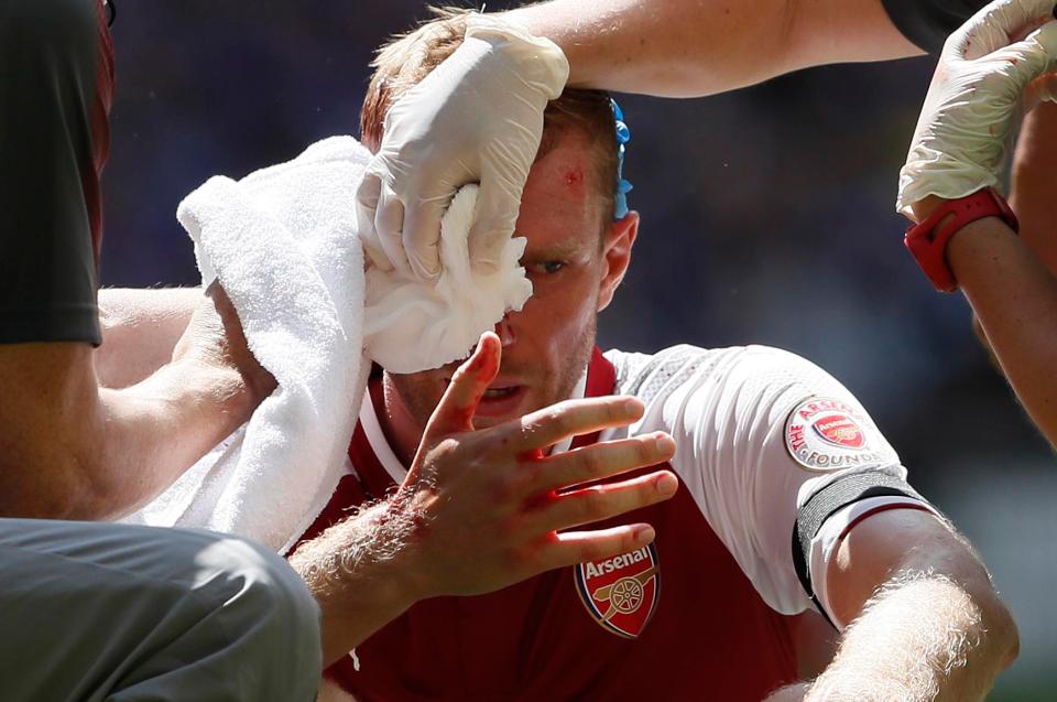 Per Mertesacker was forced off early in the first half after he was cut open by Gary Cahills elbow