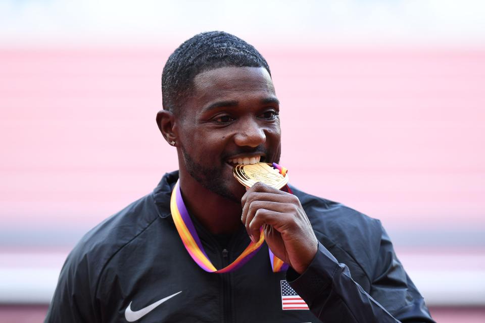 Justin Gatlin was all smiles as he received a luke-warm reception on receiving his World Championships gold