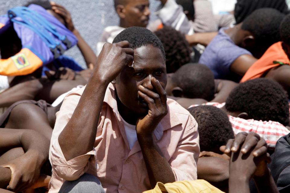  Videos of migrants being tortured by people smugglers has been posted on Facebook (file image of migrants at a detention centre in Libya)