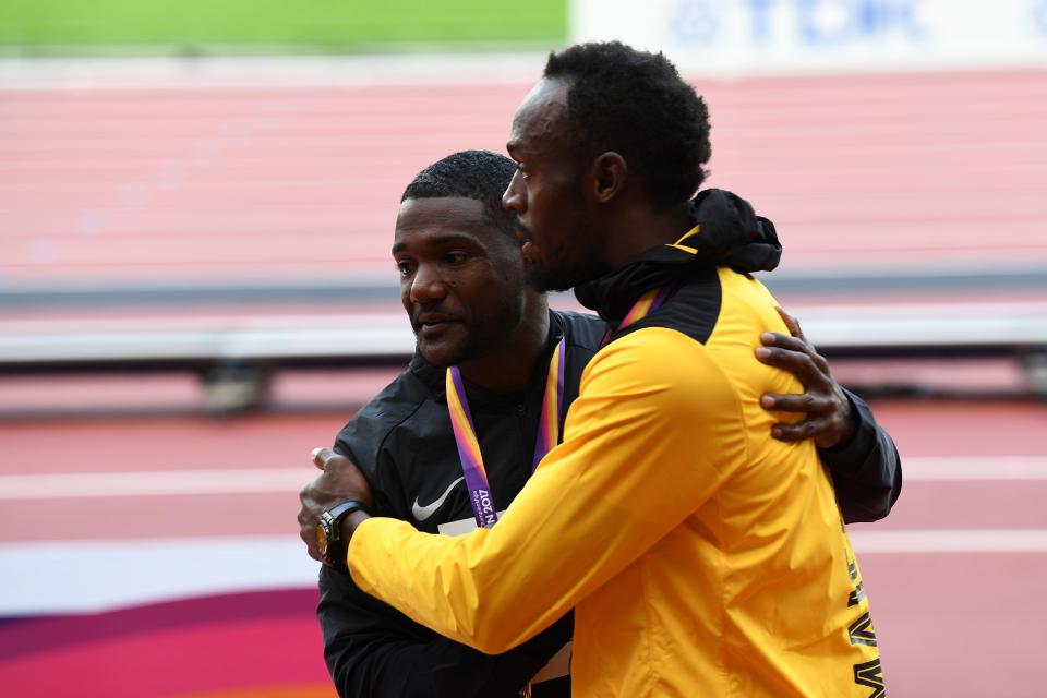 Usain Bolt and Justin Gatlin embrace each other after receiving their medals