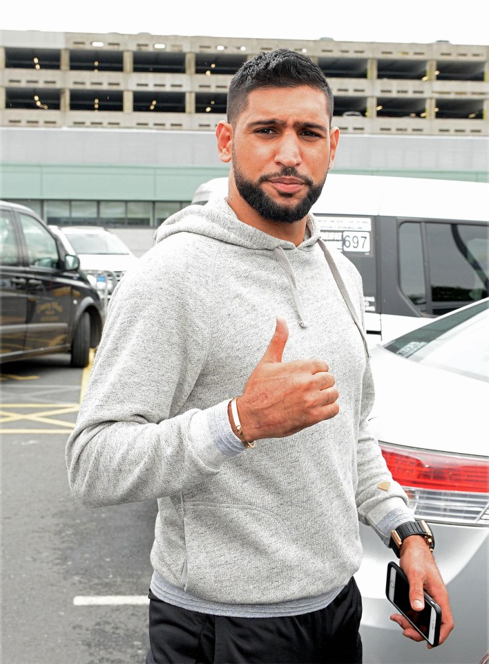 Amir Khan gave a thumbs up as he arrived at Manchester Airport