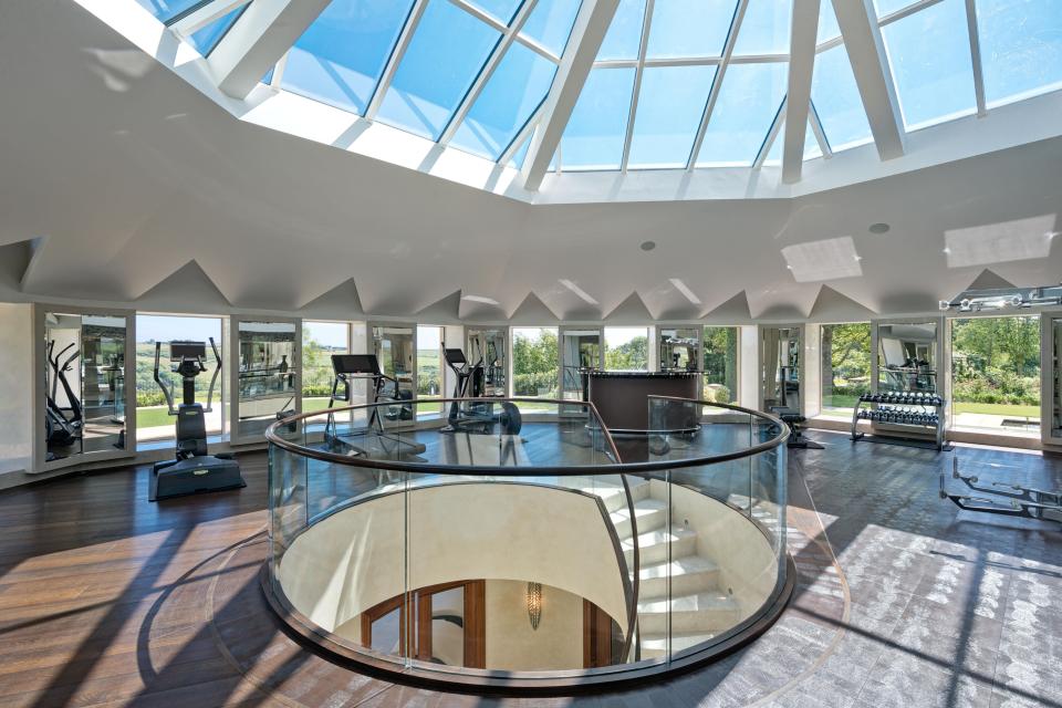 The gorgeous home features a mirrored gym with its own reception and views across the surrounding green Manx hills