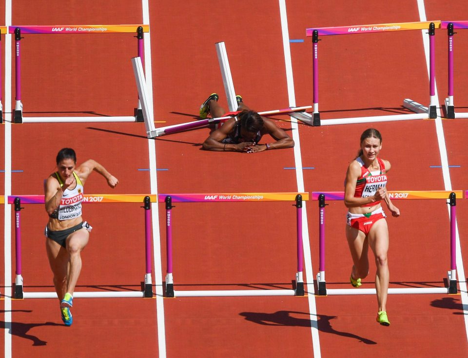 Deborah John stayed motionless on the floor after tripping over the hurdle