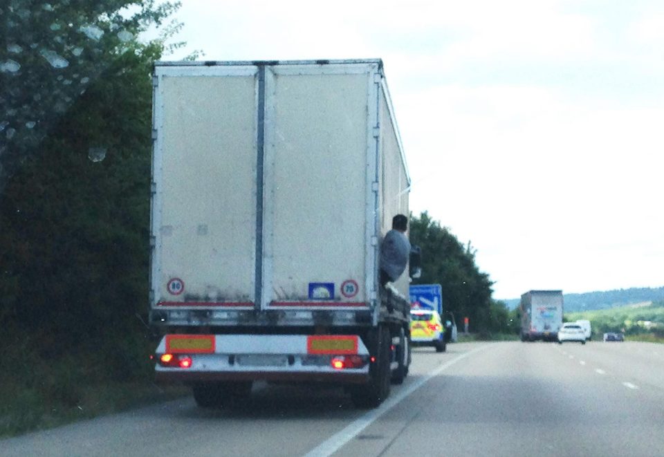  A migrant is seen trying to escape from a lorry on the M20