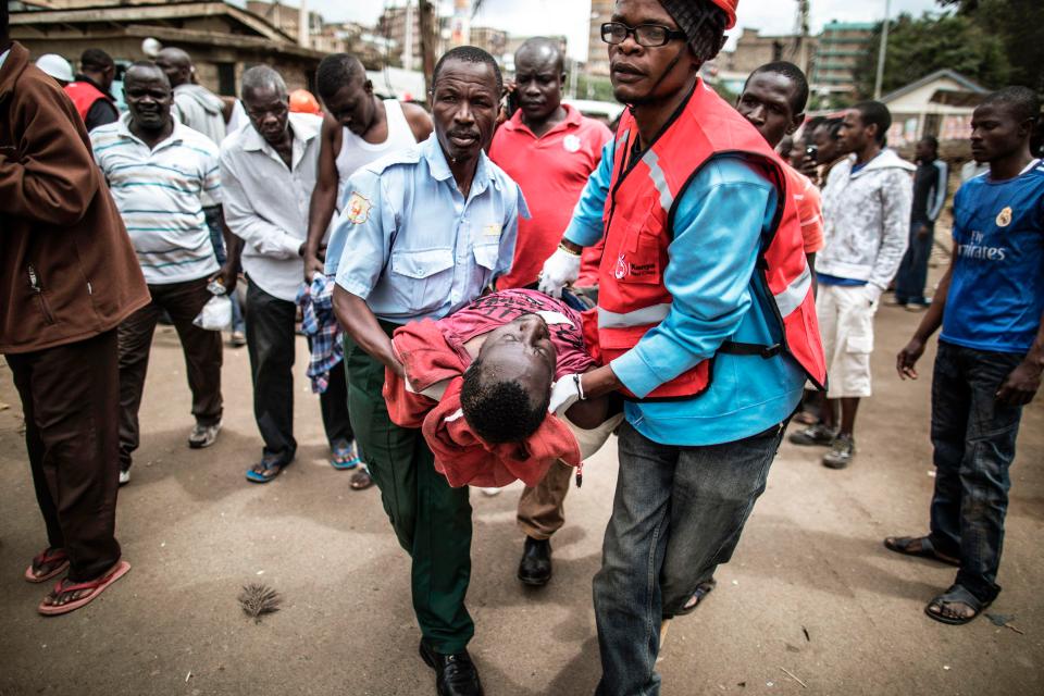  Emergency crews help a wounded man in Mathare