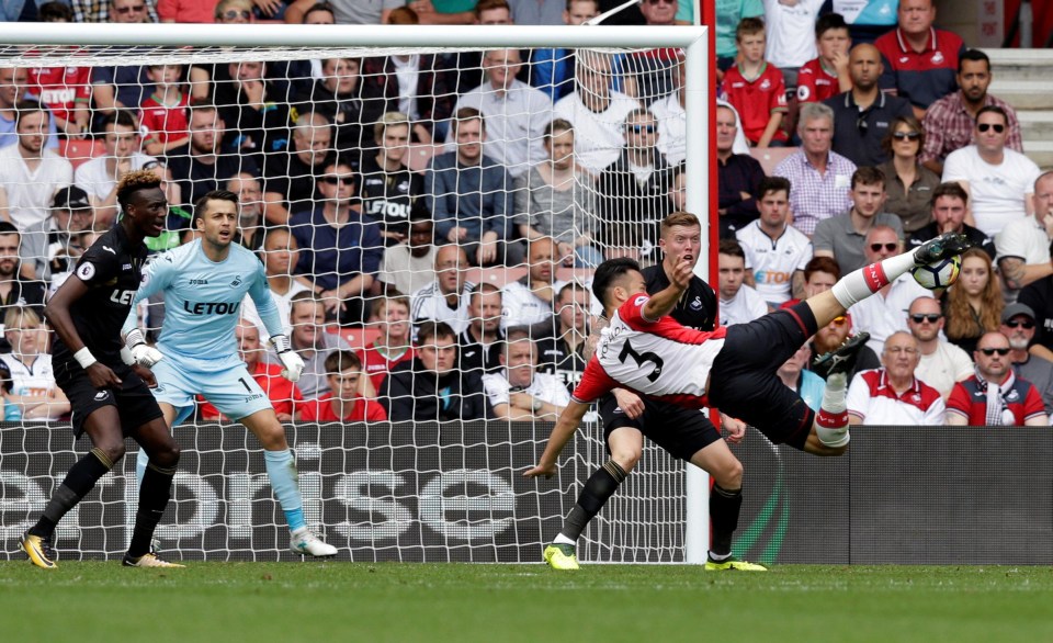 Yoshida shoots at goal as Abraham and Fabianski look on