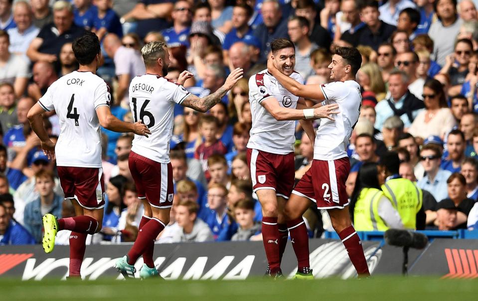 Stephen Ward is mobbed after scoring for Burnley in an amazing first half against Chelsea