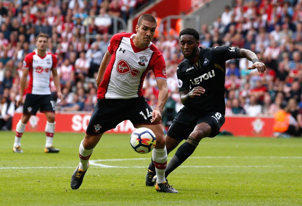 Oriol Romeu and Leroy Fer battle for the ball