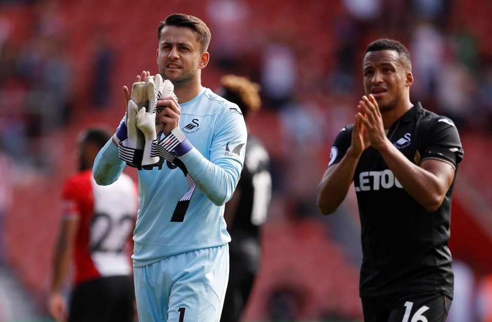 Lukasz Fabianski and Martin Olsson applaud fans after the match