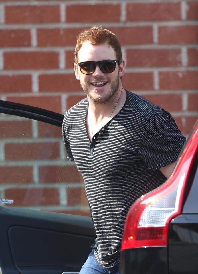  Chris Pratt flashes a grin as he gets out of his car for a weekend outing following his split from Anna Faris