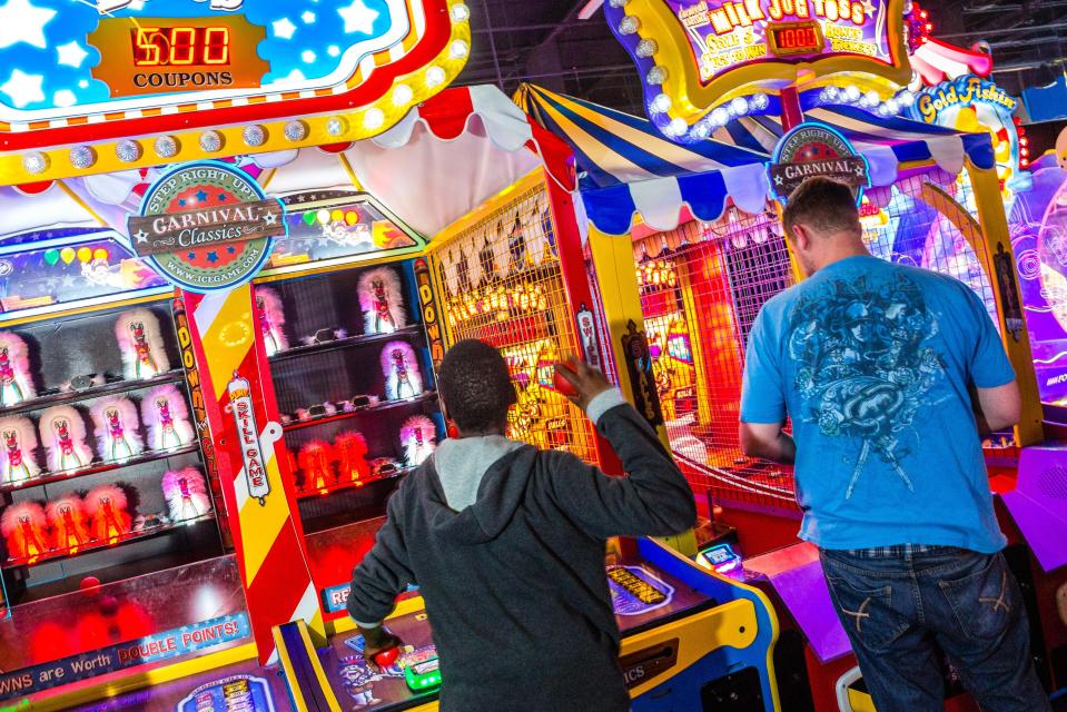  A customer tries to 'down the clown' in a New York seaside arcade