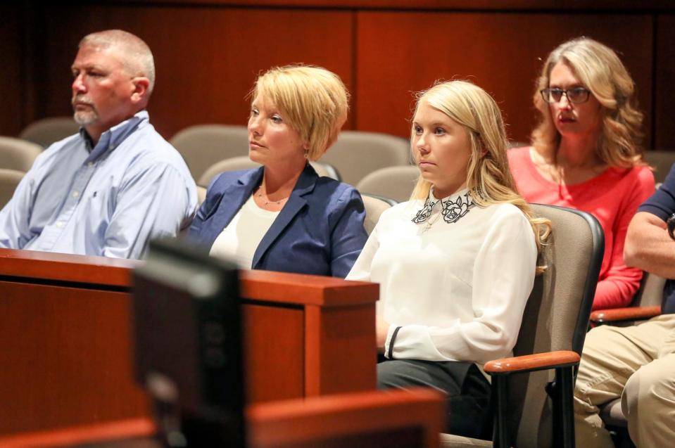  Richardson (white top) sits with her family for her pretrial hearing