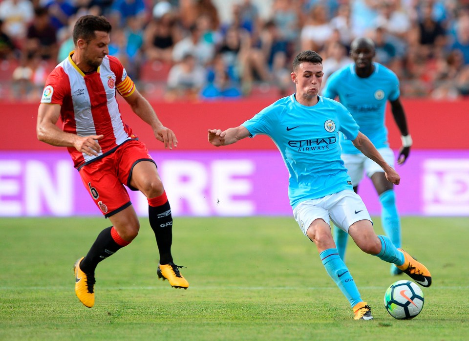 Young midfielder Phil Foden vies with Girona’s Alex Granell for the ball