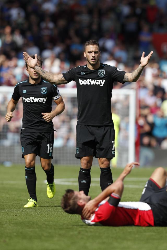 Marko Arnautovic protests his innocence as Jack Stephens clutches his neck on the floor