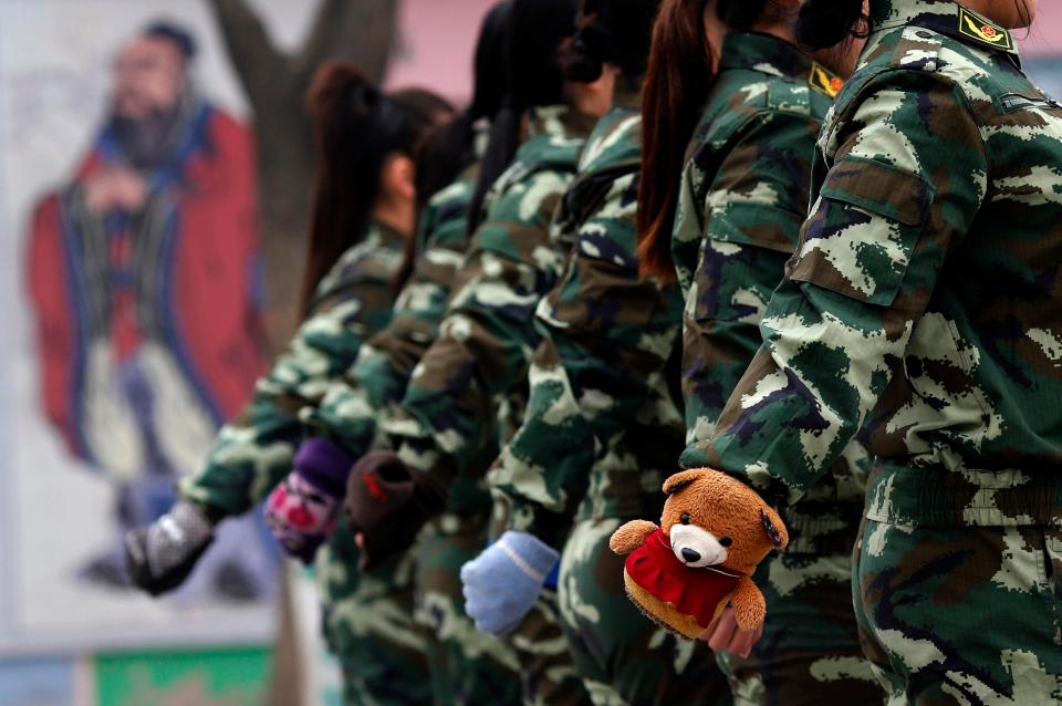  Female patients at the Qide Education Centre are allowed to wear gloves as they carry out morning drill