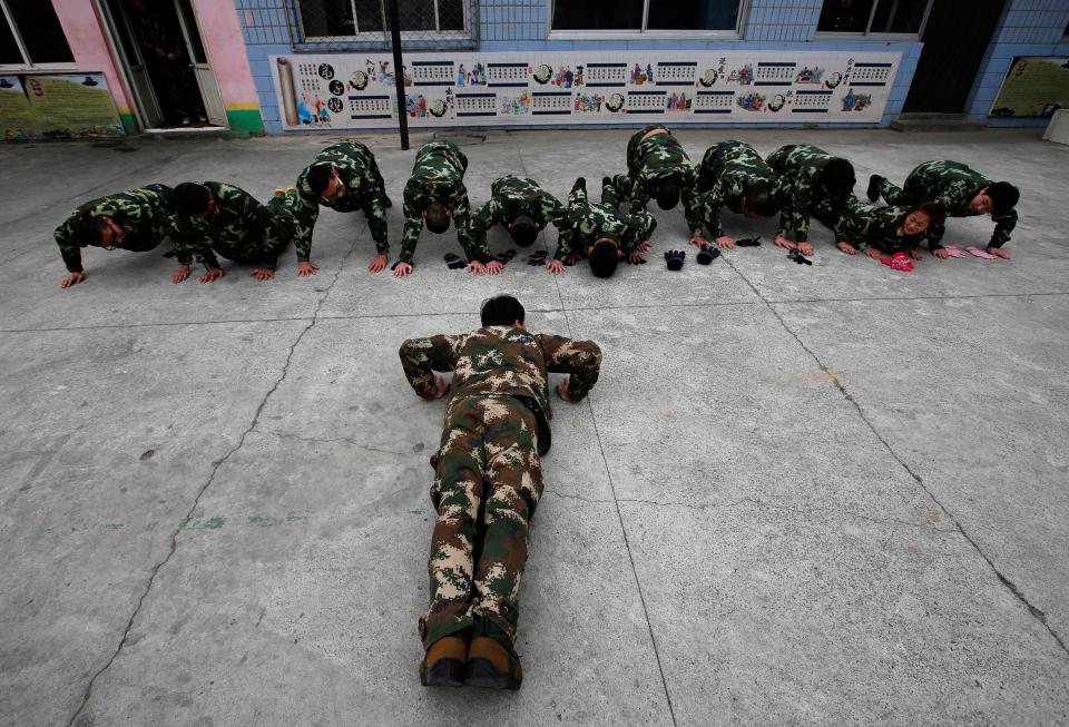  An ex-military instructor leads a group of patients doing press-ups at the Qide Education Centre in Beijing