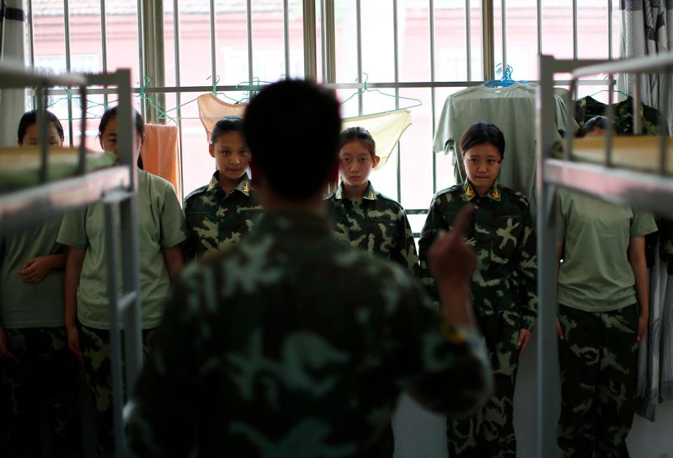  Female students are forced to stand by their beds for an inspection at a Chinese internet addiction camp