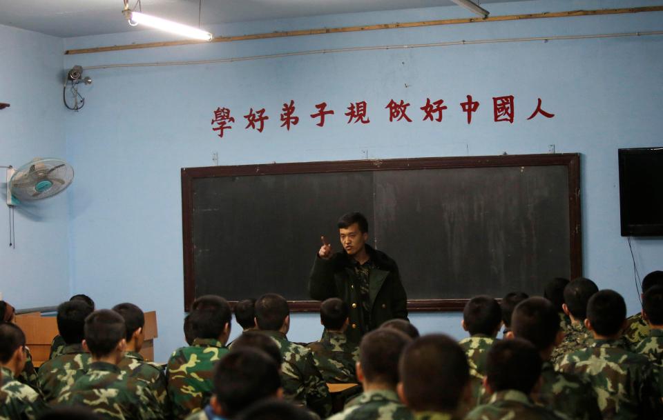  Many of the teachers at these camps are ex-military instructors. Pictured is one giving students a lesson at the Qide Education Centre in Beijing