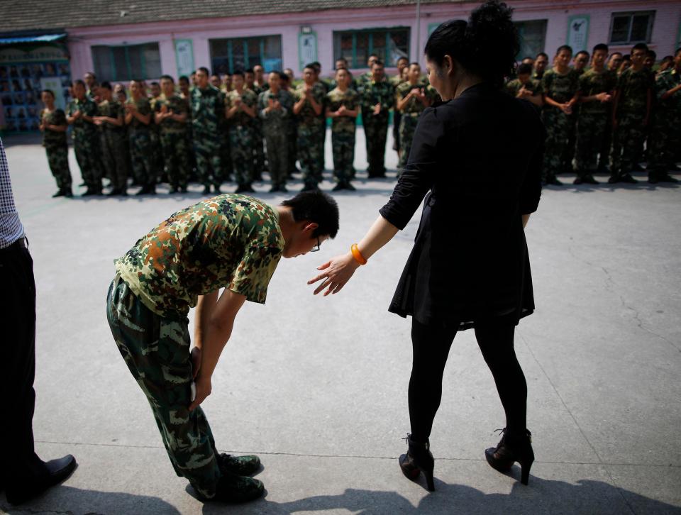  A patient who has completed a six-month addiction course bows to the head teacher