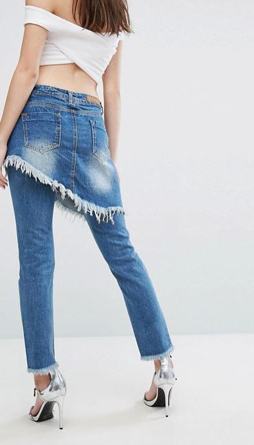  The double denim look includes an asymmetrical skirt worn over a pair of ripped jeans