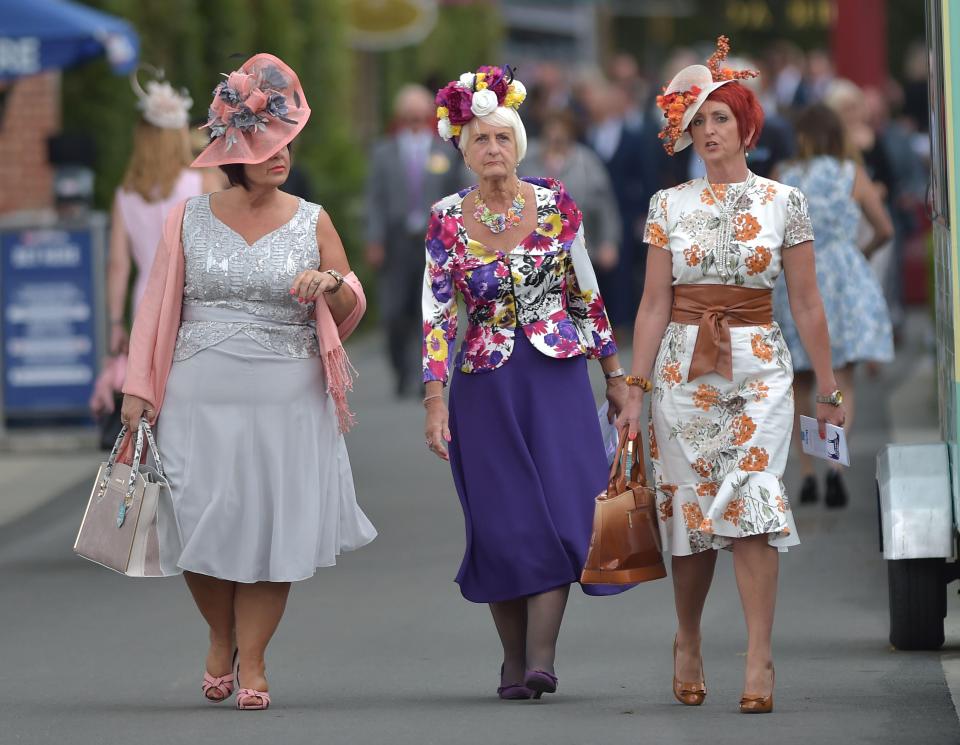  Three pals in brightly coloured outfits were papped on their way into York races earlier on today