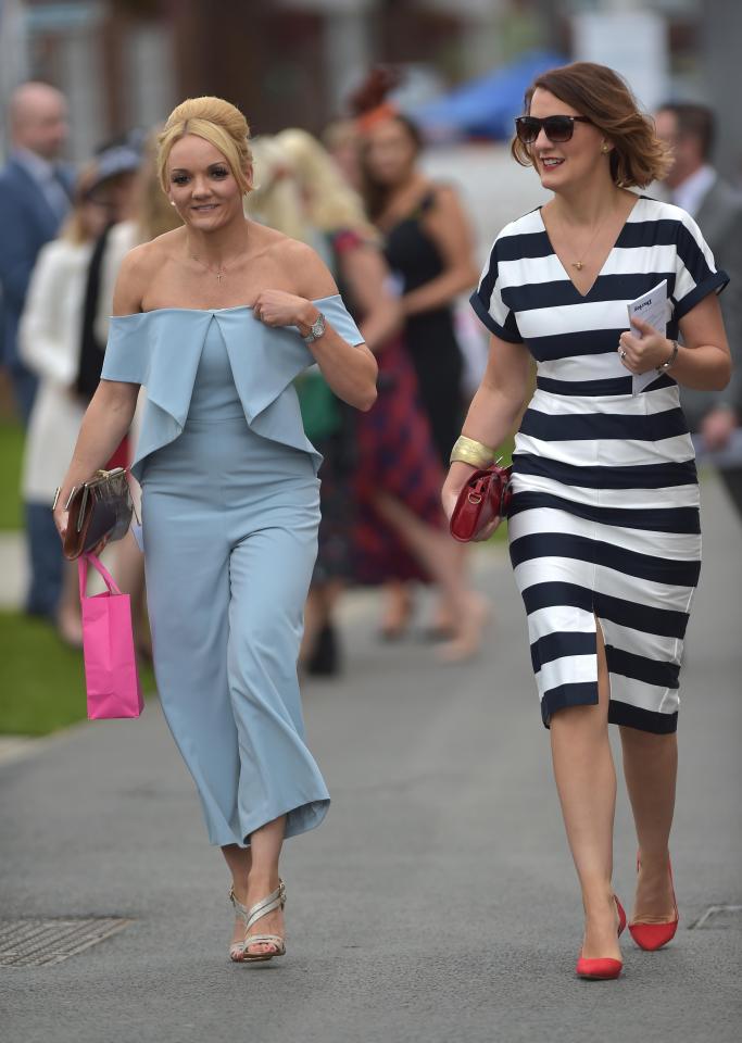  One woman stunned in a strapless blue jumpsuit, while her pal looked chic in a monochrome striped dress