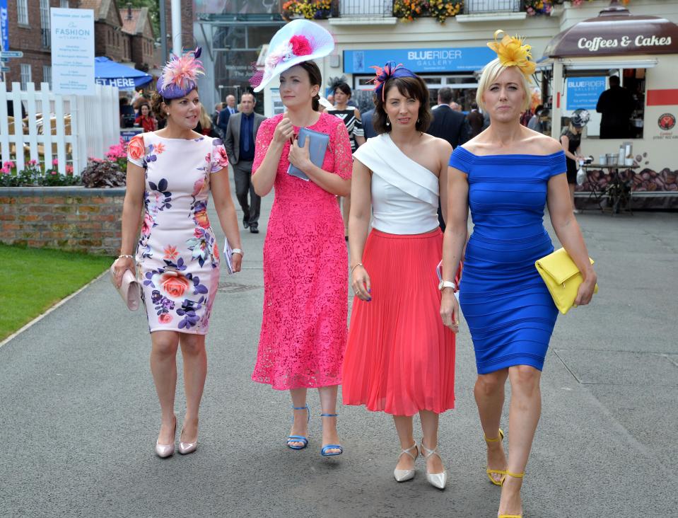  High-spirited racegoers descended on the Ebor Festival today in an array of pretty colourful dresses, elaborate head wear and towering high heels