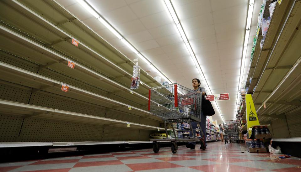  Shelves have been stripped bare as people buy food and water while they wait out the storm