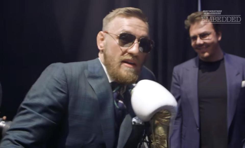  Conor McGregor looked happy with his white and gold Everlast gloves