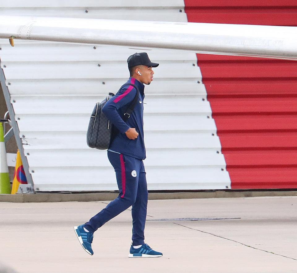 Gabriel Jesus looks very focused as he makes his way onto the aircraft