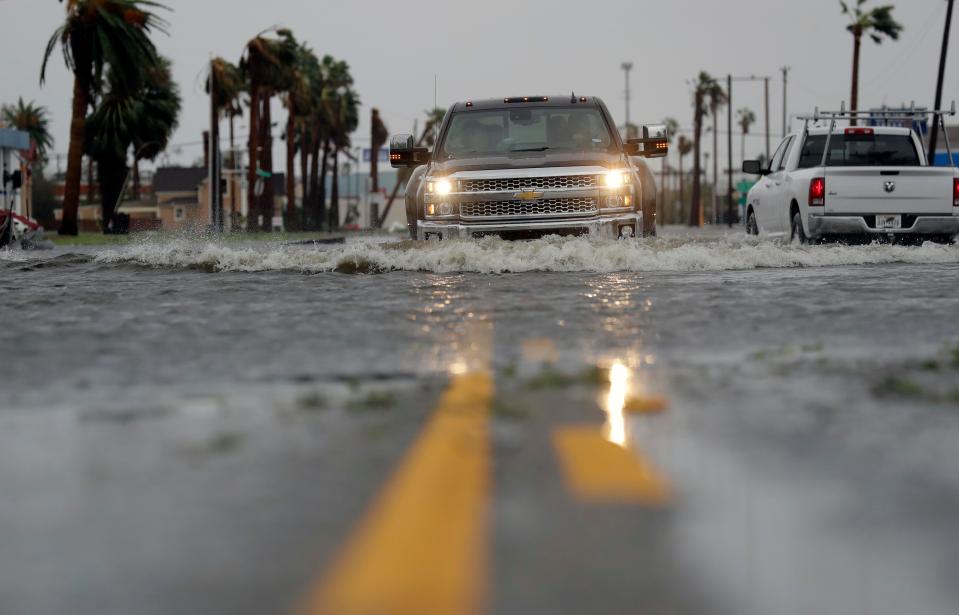 A car moves through floodwaters left behind by Hurricane Harvey in Aransas Pass, Texas