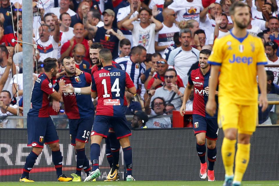 Genoa players celebrate taking a two-goal lead, but they would let it slip