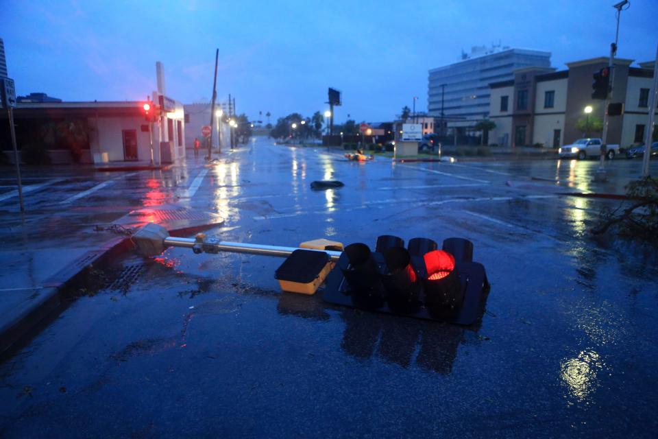  A smashed traffic light lies across the road after being knocked down in heavy wind