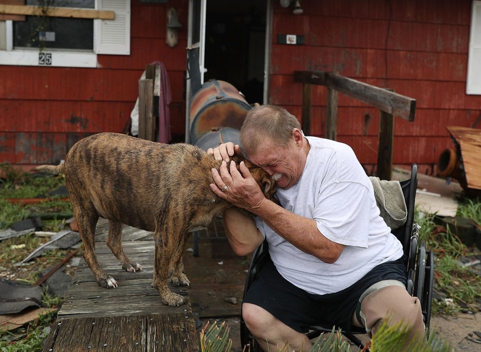  Steve Culver cries with his dog Otis as he talks about what he said was the, "most terrifying event in his life," when Hurricane Harvey blew in and destroyed most of his home