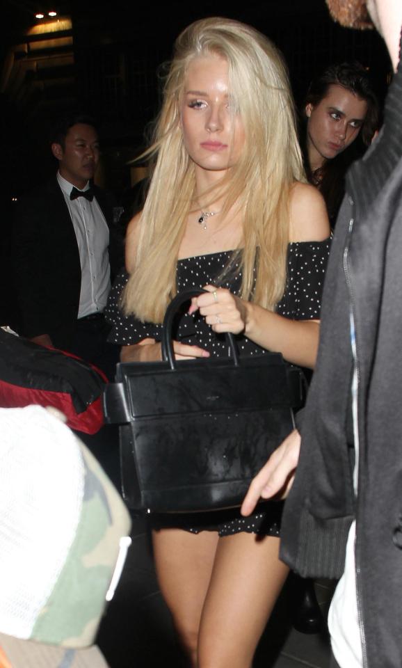  Bleary-eyed Lottie Moss got a soaking as a lively party-goer threw a drink on her as she left a London club