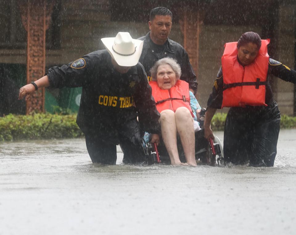  Pictured, a pensioner is rescued from her home in Brays Bayou, Texas, as the flood water continues to rise