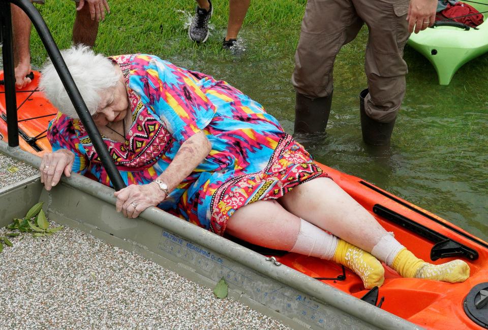  Pictured, Sterling Broughton is moved from a rescue boat on to a kayak in Dikinson, Texas