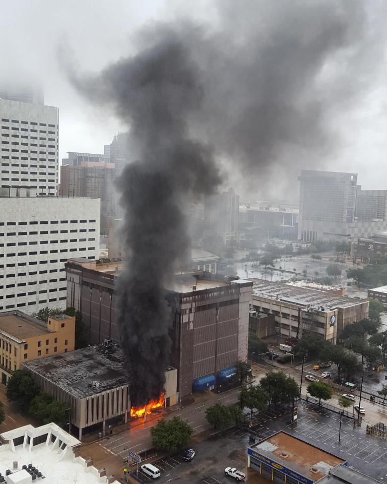 Smoke and flames rise from a building in Houston