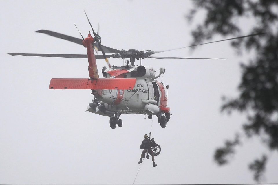 A victim in a wheelchair is air lifted to safety in Houston