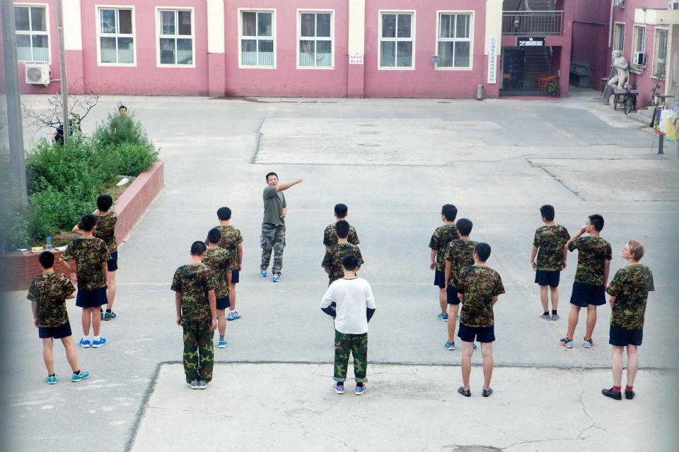  Jamie Fullerton (far right) receives instructions with other patients while standing in the courtyard of the internet addiction treatment centre