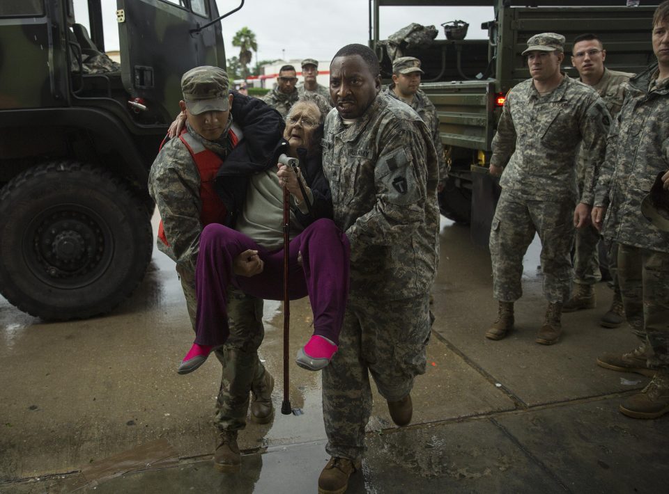  Texas Army National Guard members carry a rescued resident in Houston