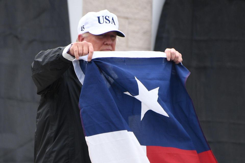  The gesture was met with rapturous applause from waiting Texans