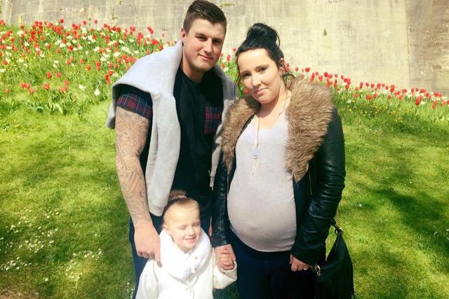 Taylor, pictured before the crash with pregnant girlfriend Emma and their daughter Tiarna, was in intensive care for a month