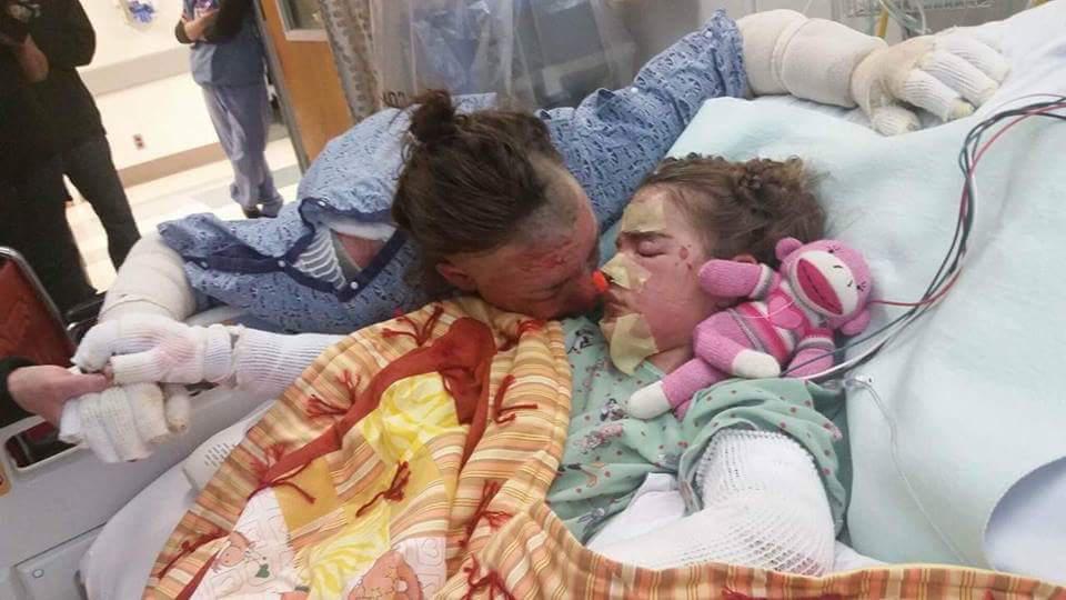  Angel kisses Gianna in hospital in October. It was the first time she'd seen her daughter since the fire