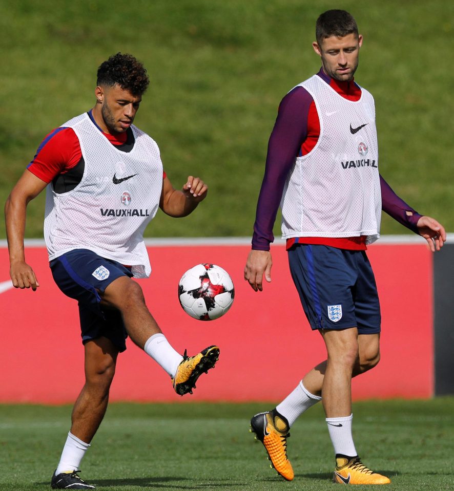 Oxlade-Chamberlain limbers up for the Malta game alonsgide Chelseas Gary Cahill