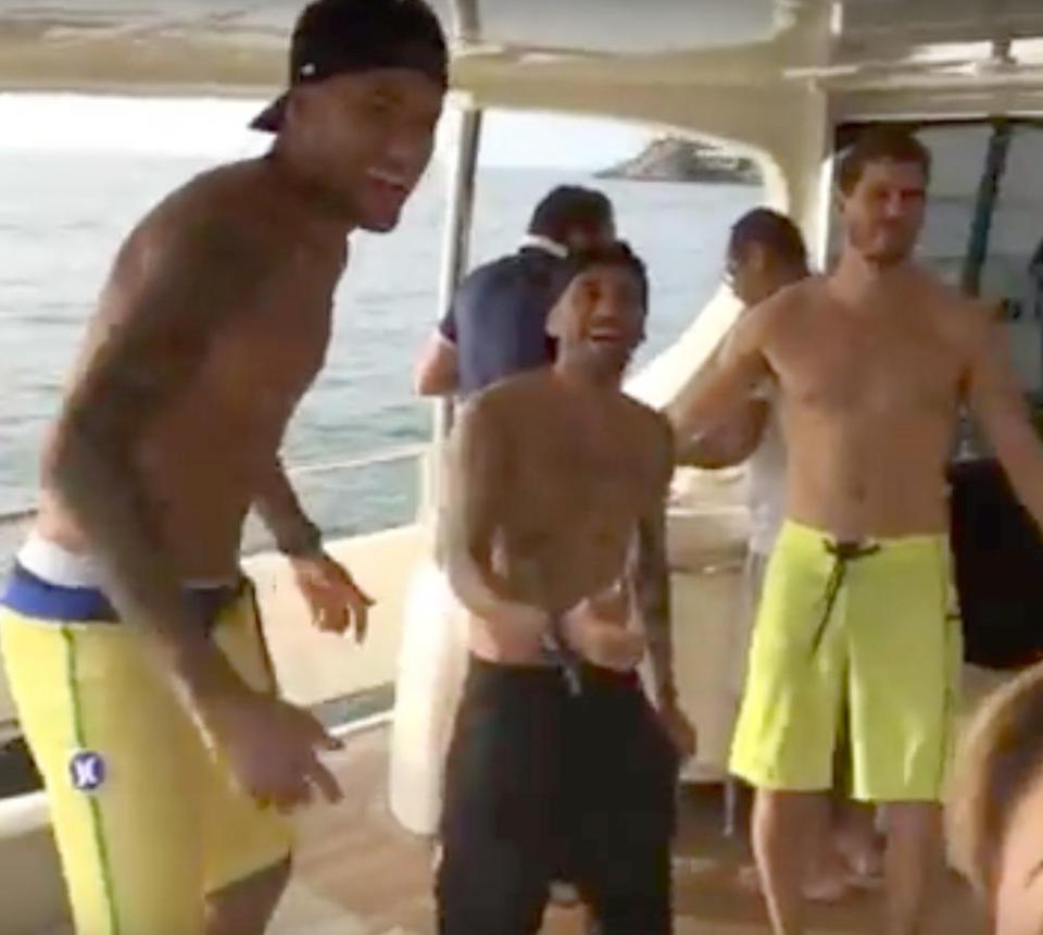  Neymar, left, can be seen laughing with Dani Alves, centre, as they belt out a Brazilian anthem